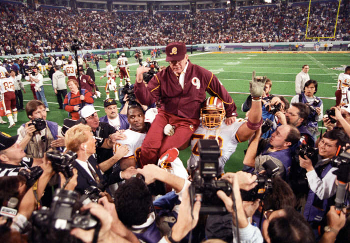 Washington Redskins head coach Joe Gibbs is carried on the field after defeating the Buffalo Bills during Super Bowl XXVI at the Metrodome. The Redskins defeated the Bills 37-24. Mandatory Credit: RVR Photos-USA TODAY Sports